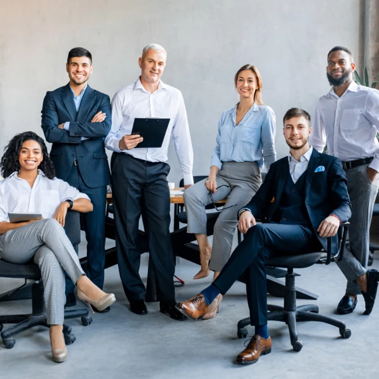 Group of employees posing in front of a camera